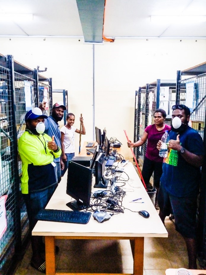 The Vanuatu Meteorology and Geohazards Department staff in action - scraping a few edges in the National Climate Archive room.