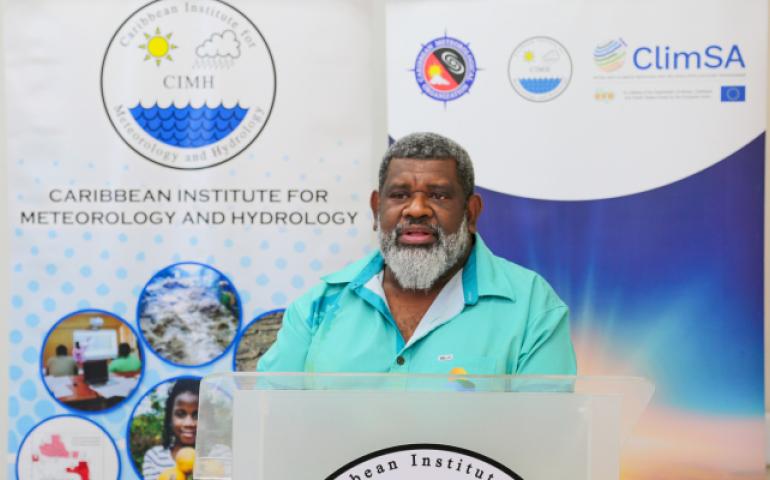 Mr Salesa Nihmei, Director of the new Climate Science & Information Programme at SPREP. In the background are pull up banners about the projects.