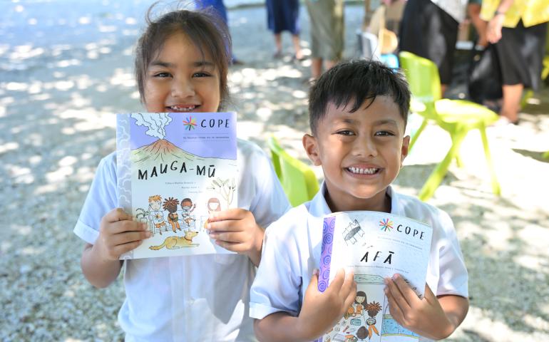 Students of Matiti School on Nukunonu, Tokelau smile receiving the new COPE Booklets