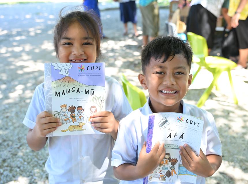 Students of Matiti School on Nukunonu, Tokelau smile receiving the new COPE Booklets